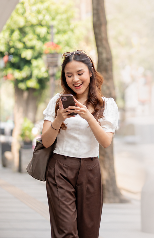 Woman using smartphone happily